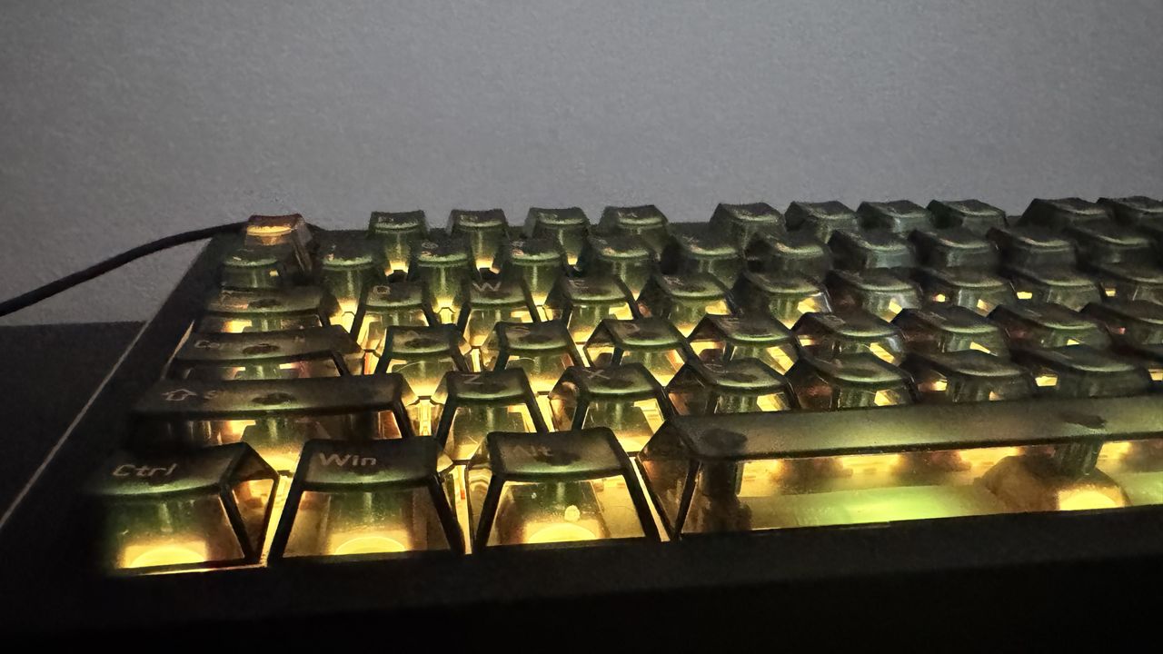 Melgeek Real 81 gaming keyboard on a desk, from the front, showing off its RGB lighting