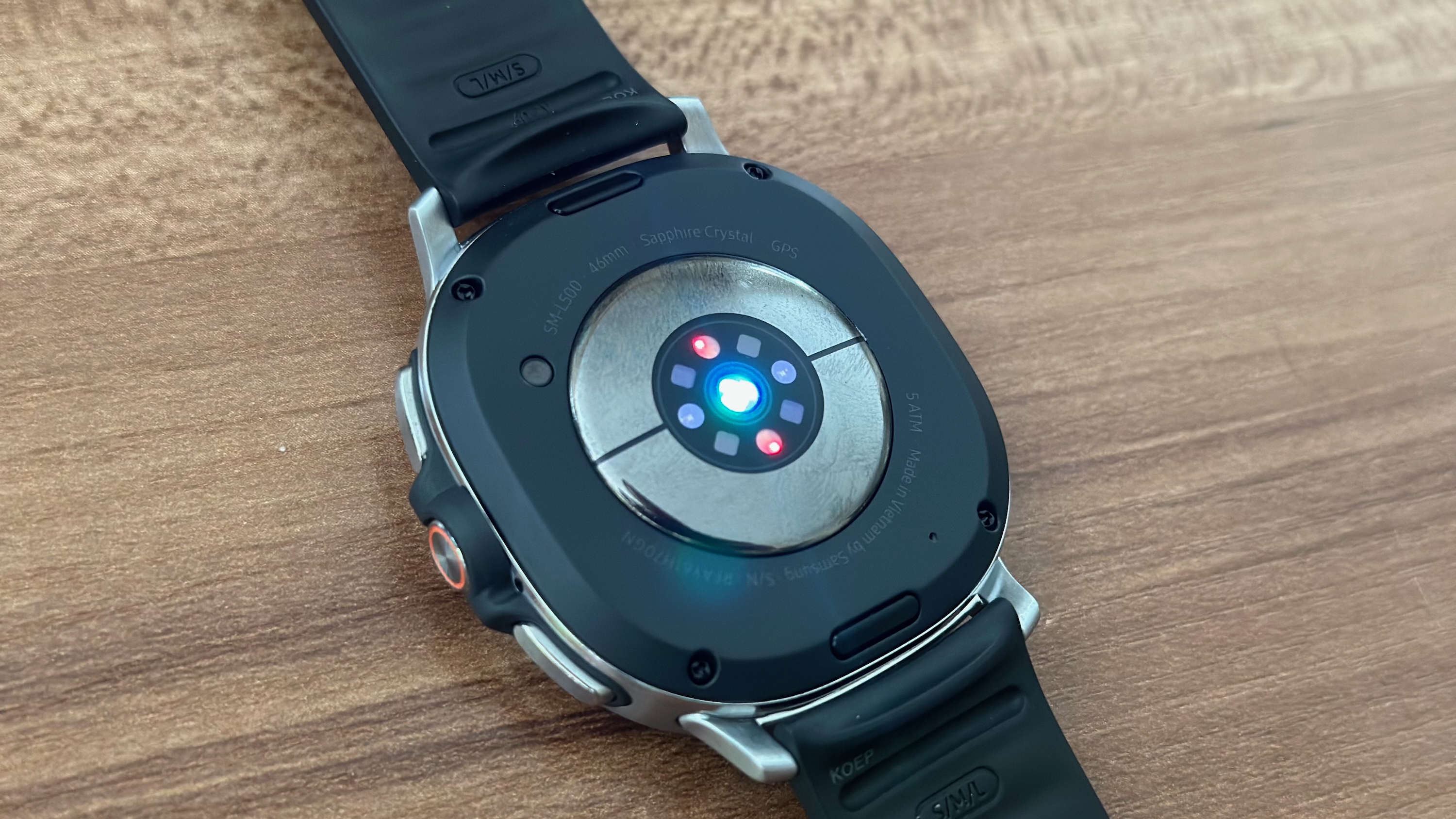 The Samsung Galaxy Watch 8 Classic's bottom BioActive sensor with green, red, and blue lights activated when testing your skin for antioxidants.