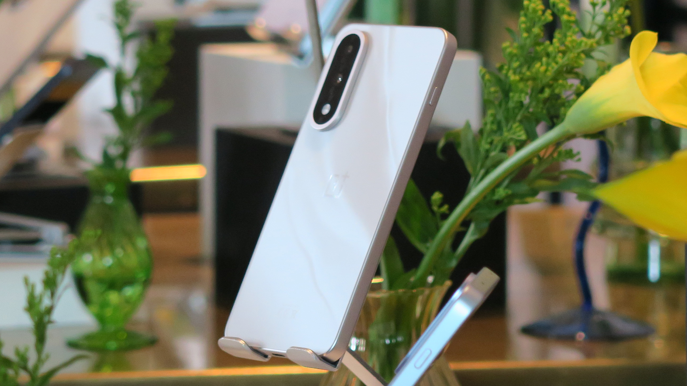 The OnePlus Nord 5 in Marble Sands on a plinth