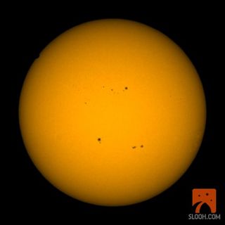 This view from the Slooh Space Camera shows the amazing start of the 2012 transit of Venus across the sun (upper left) as it begins to cross the solar disk on June 5, 2012.