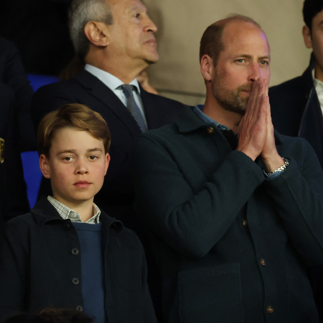 Prince George and Prince William attend a football match