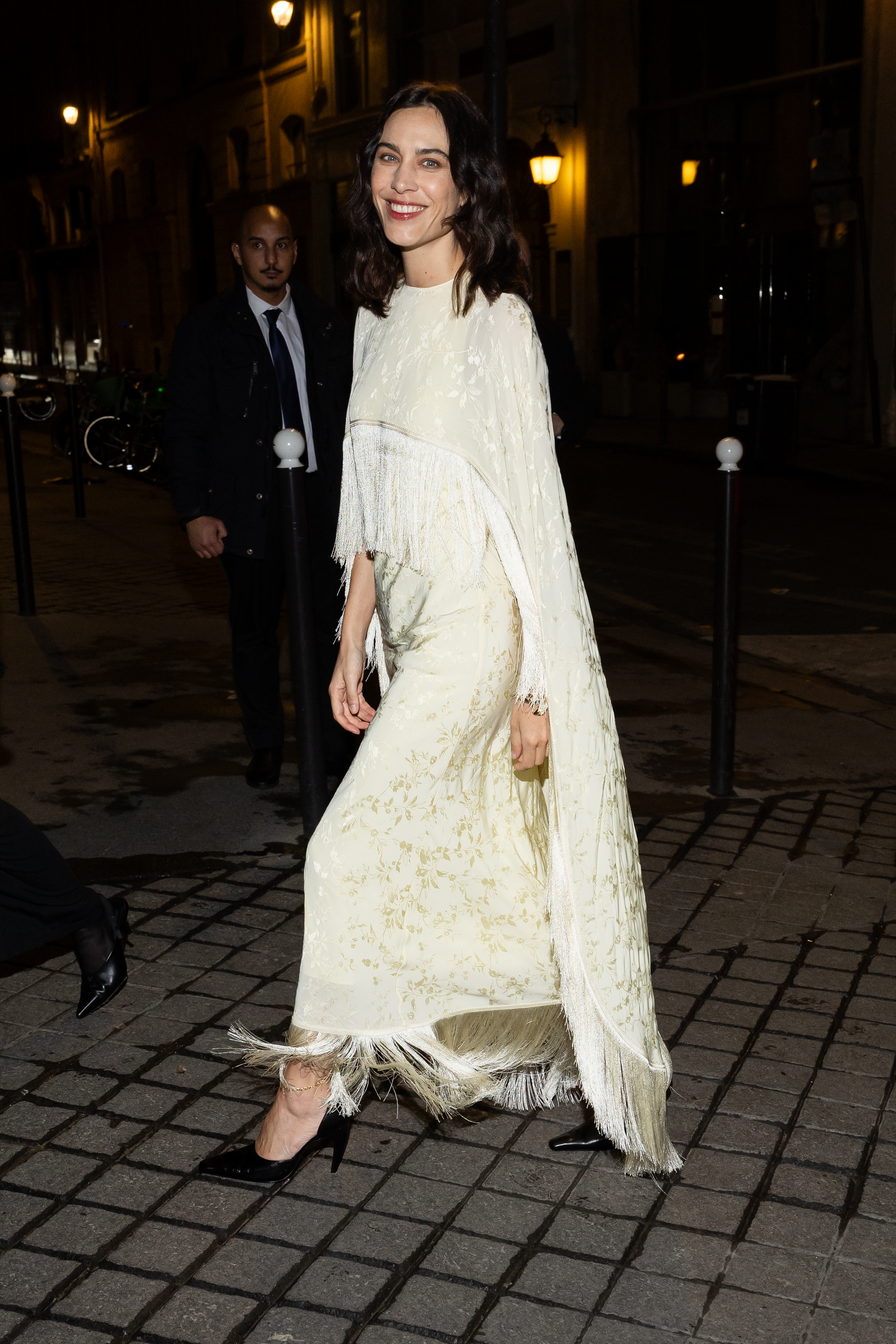 Alexa Chung wears a tassel dress with black curved heel shoes.