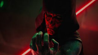 Maul (Sam Witwer) in a hood, using the force, with his dual lightsaber drawn in Maul &ndash;&nbsp;Shadow Lord