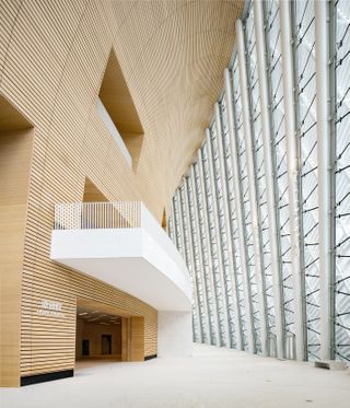 The double-curved interior wall surfaces are clad in bamboo and envelope circulation and gallery spaces.