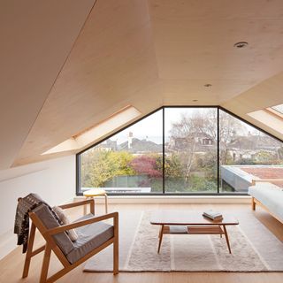 living room loft room looking out over the garden via an oversized wall of glazing