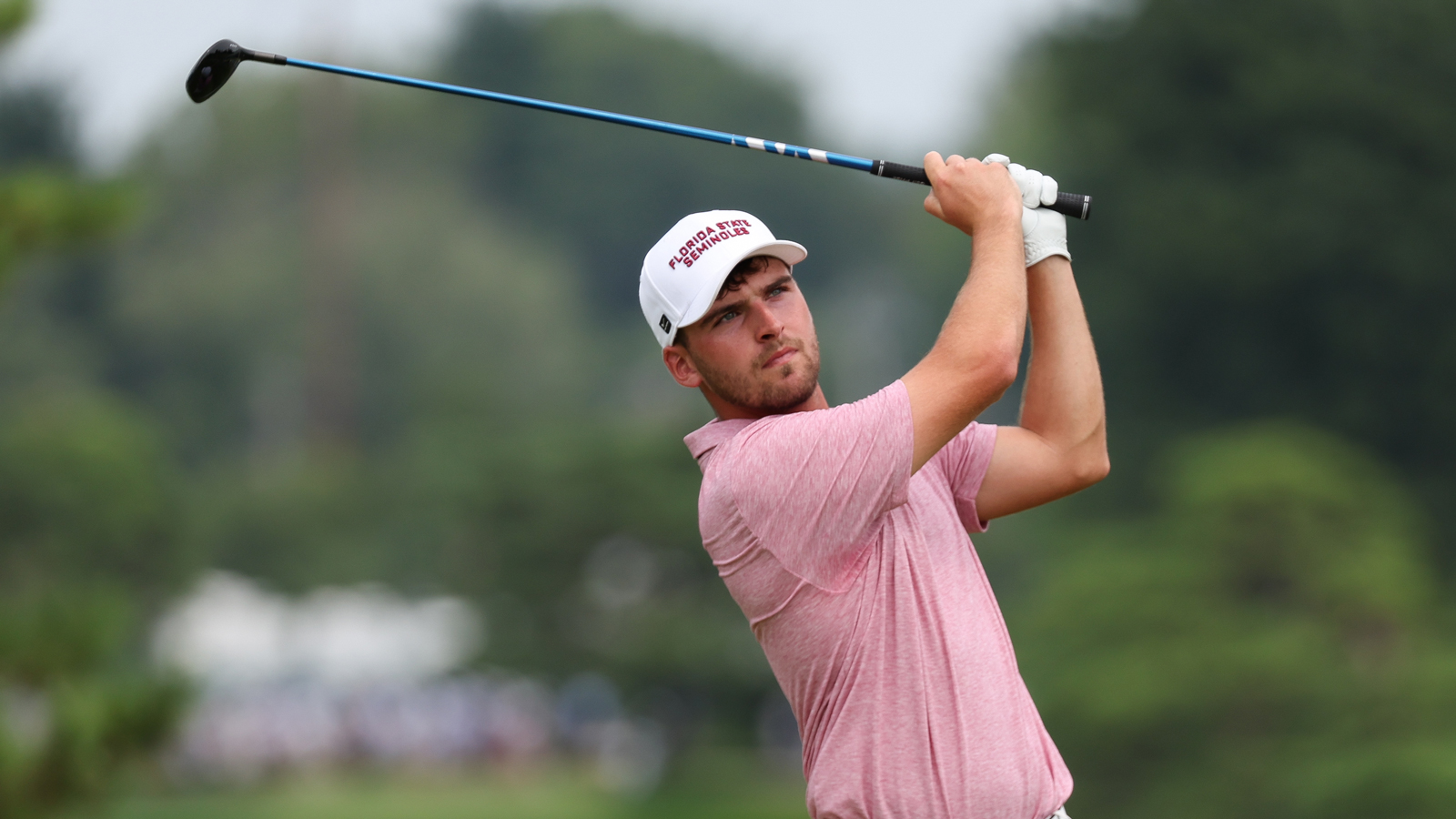 Jack Whaley hits a tee shot and watches the flight of it