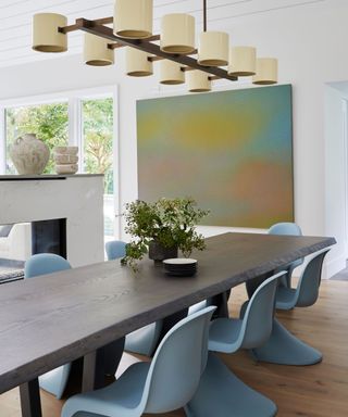 dining room with blue chairs and modern art