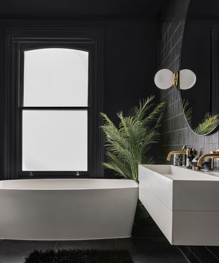 modern black color drenched bathroom with white fixtures