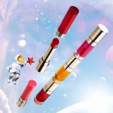 Clarins lipsticks on a dreamy festive background with a toy astronaut