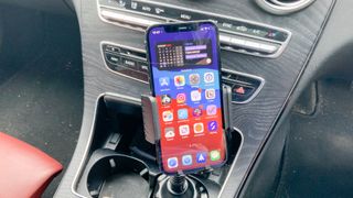 TOPGO Cup Holder Phone Mount shown holding an iPhone