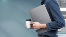 Honor MagicBook 16 (2022) review: man carrying laptop and coffee