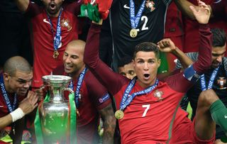 Cristiano Ronaldo celebrates Portugal's Euro 2016 final win over France alongside his team-mates at the Stade de France in July 2016.
