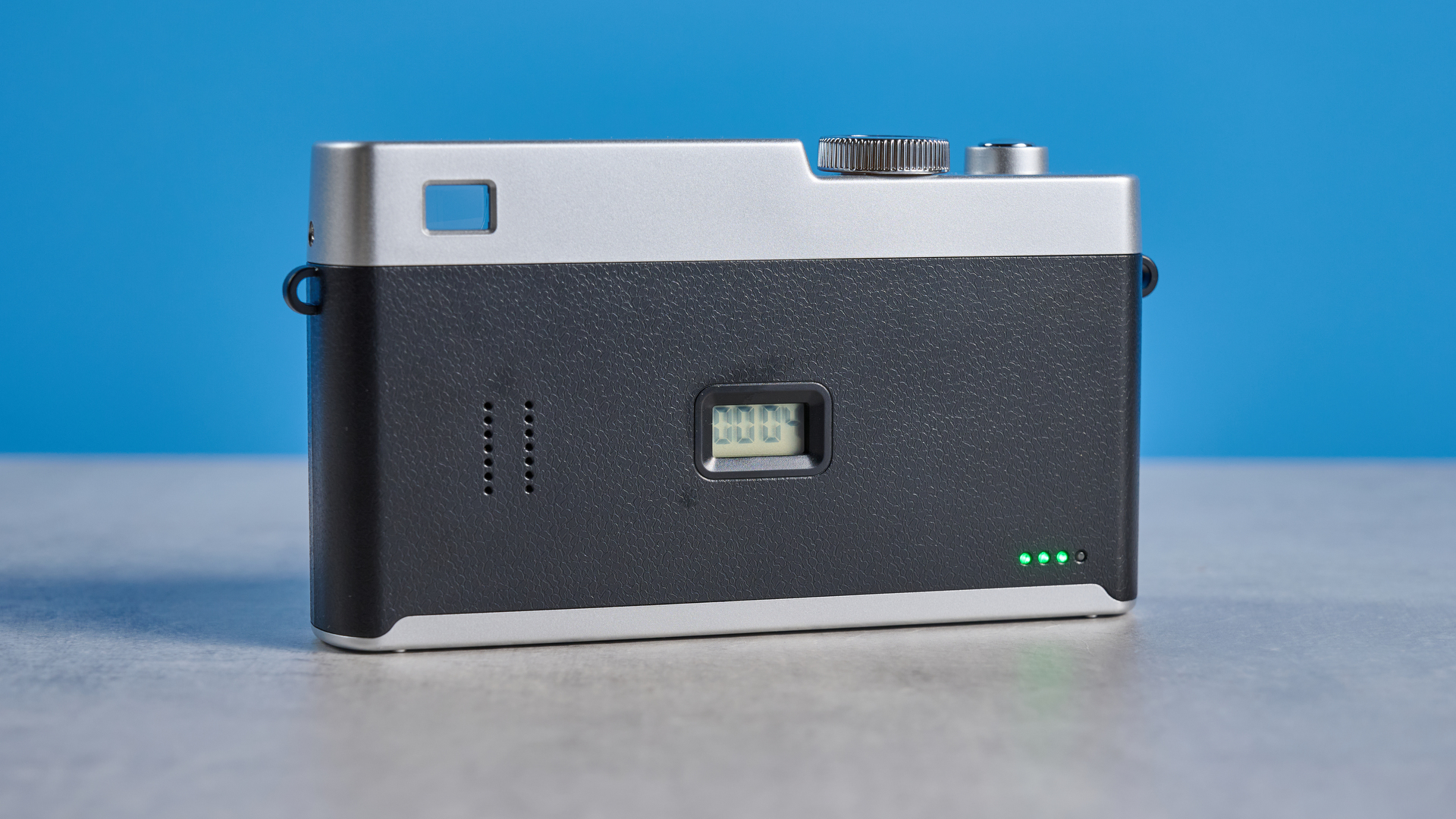 Camp Snap CS-Pro in black and silver photographed on a blue background