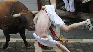 A Jandilla bull charges at a participant during the first "encierro" (bull-run) of the San Fermin Festival in Pamplona, northern Spain, on July 7, 2015. The festival is a symbol of Spanish cu