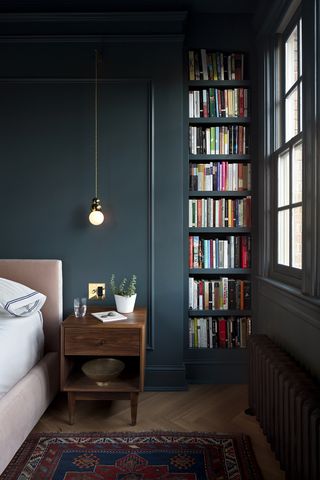blue bedroom with books lining the shelves