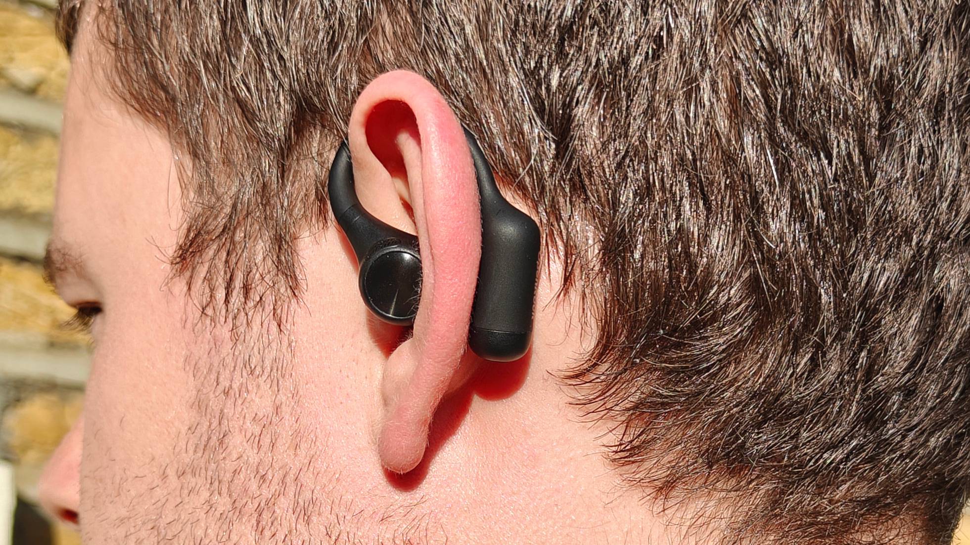 The OpenRock S2 on a man's ear.
