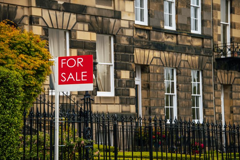for sale sign outside a house
