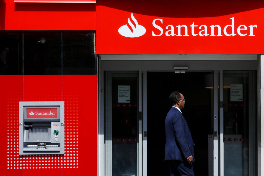 A pedestian passes a bank branch of Banco Santander SA in London, U.K