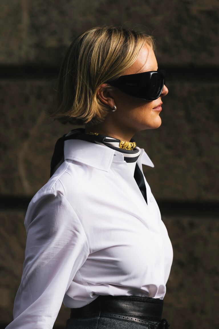 a fashion week guest wearing bug eye sunglasses