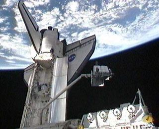 Astronauts Unload Spare Parts Platform At Space Station