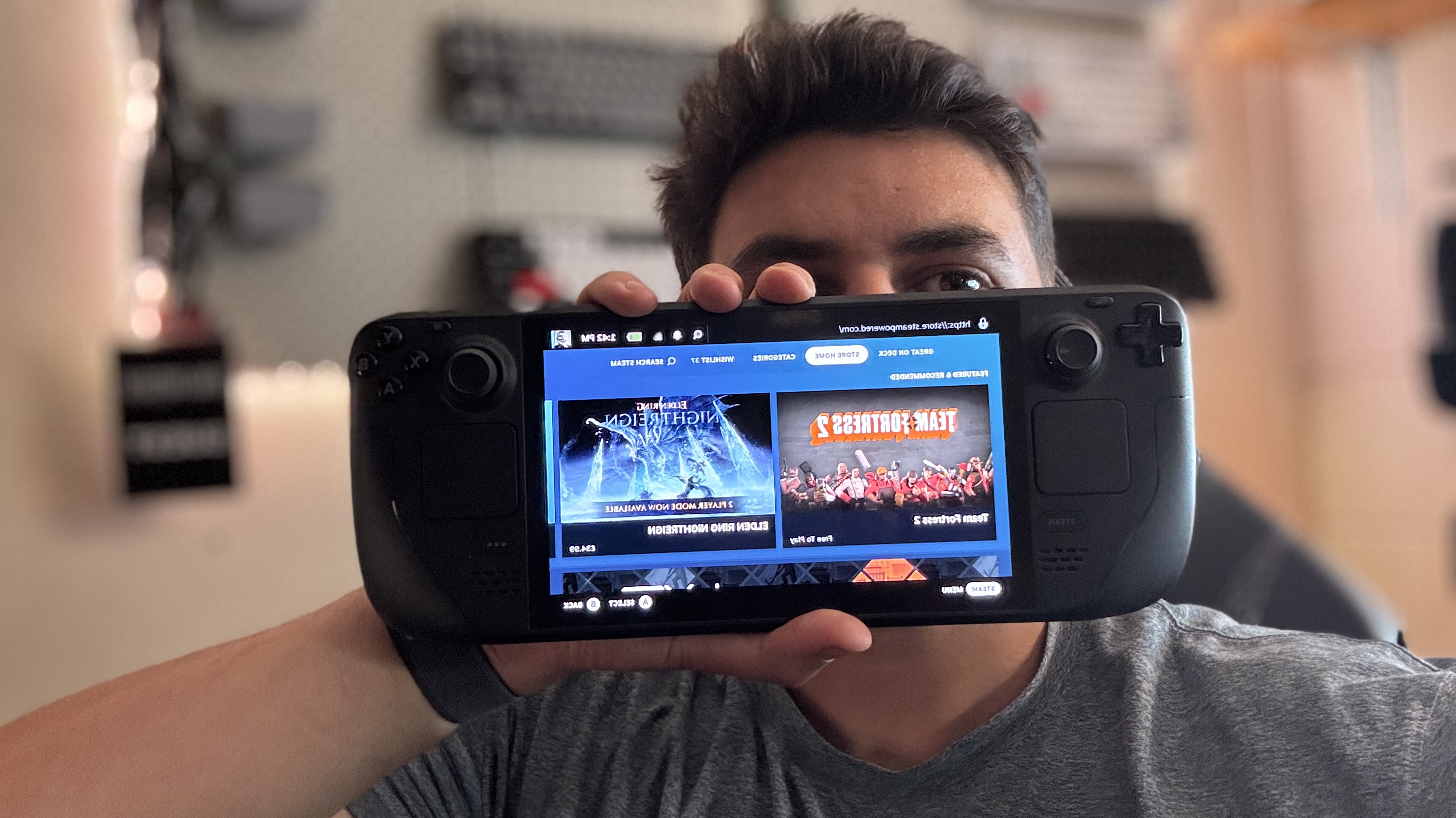 Writer holding Steam Deck OLED