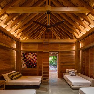 Bedroom in coastal mexican home built with wood