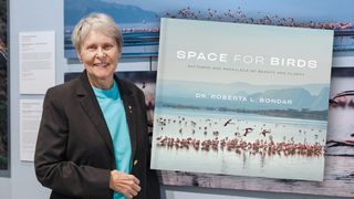 Former Canadian astronaut Roberta Bondar poses with her photos of the lesser flamingo, part of the AMASS (Avian Migration Aerial, Surface, Space) research project and her newly-released book, &quot;Space for Birds: Patterns and Parallels of Beauty and Flight.&quot;