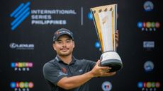 Miguel Tabuena poses with the International Series Philippines trophy after winning in 2025