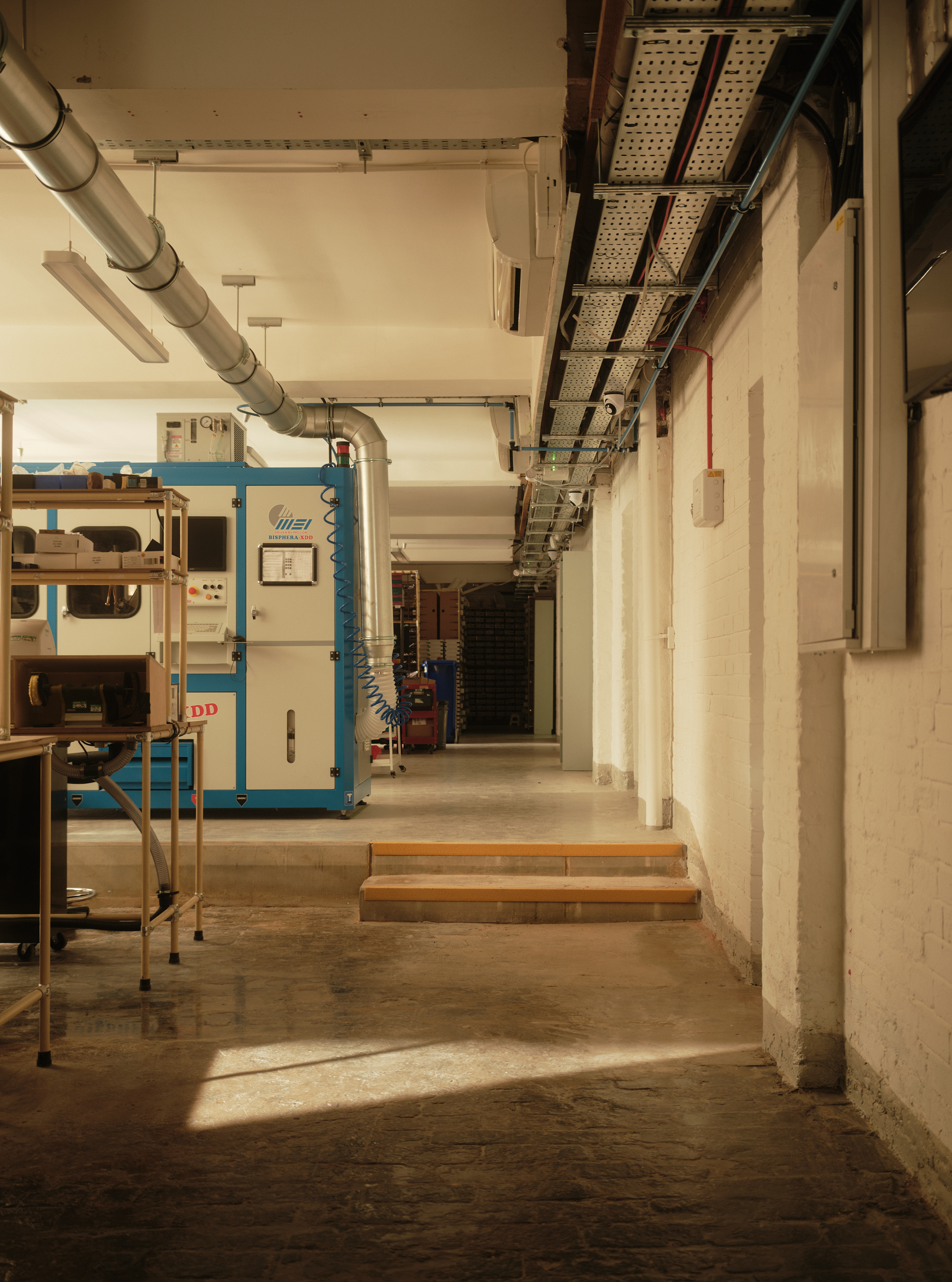 new Cubitts headquarters interior, refurbished warehouse type building with raw materiality and colour pops