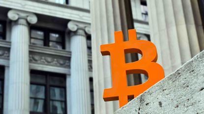 A colorful Bitcoin logo sitting on courtroom steps