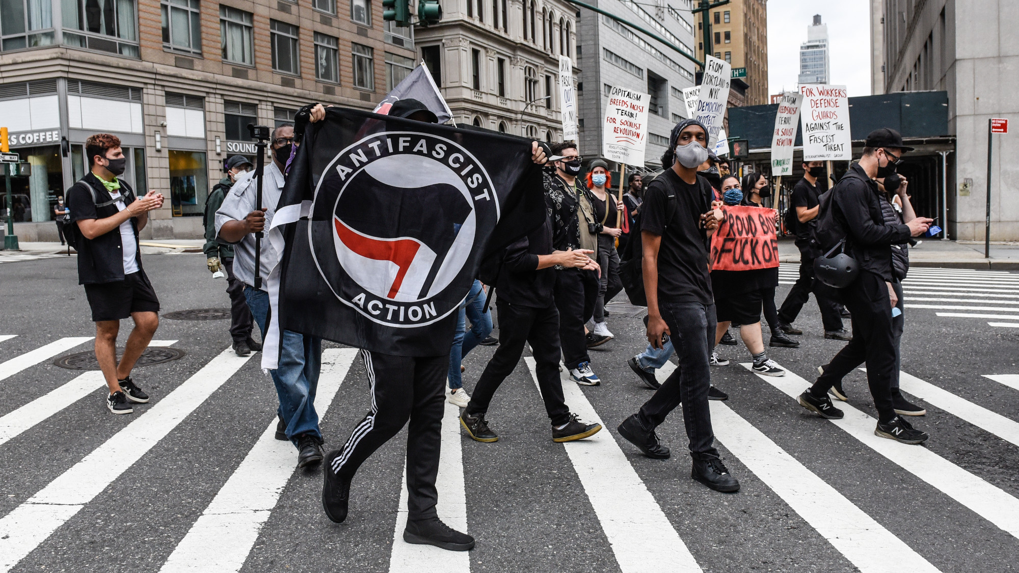 A protestor holds up an antifa flag during a protest in New York City