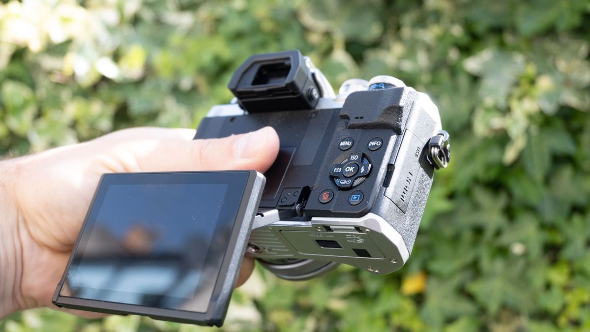 Olympus OM-D E-M10 Mark IV with rear screen flipped out and in-hand