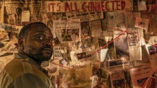 Brian Tyree Henry stands in front of his conspiracy board in Godzilla x Kong: The New Empire.