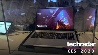 a laptop housing the intel xe dg1 chip at ces 2020, locked behind a glass case and playing destiny 2