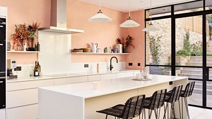 a white kitchen with a limewash wall