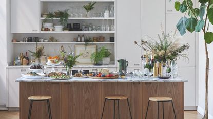 A kitchen island set up as a cocktail bar