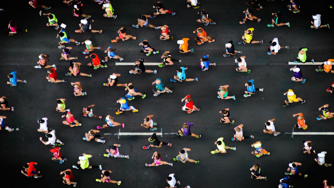 brid&#039;s eye view of a group of people running on tarmac