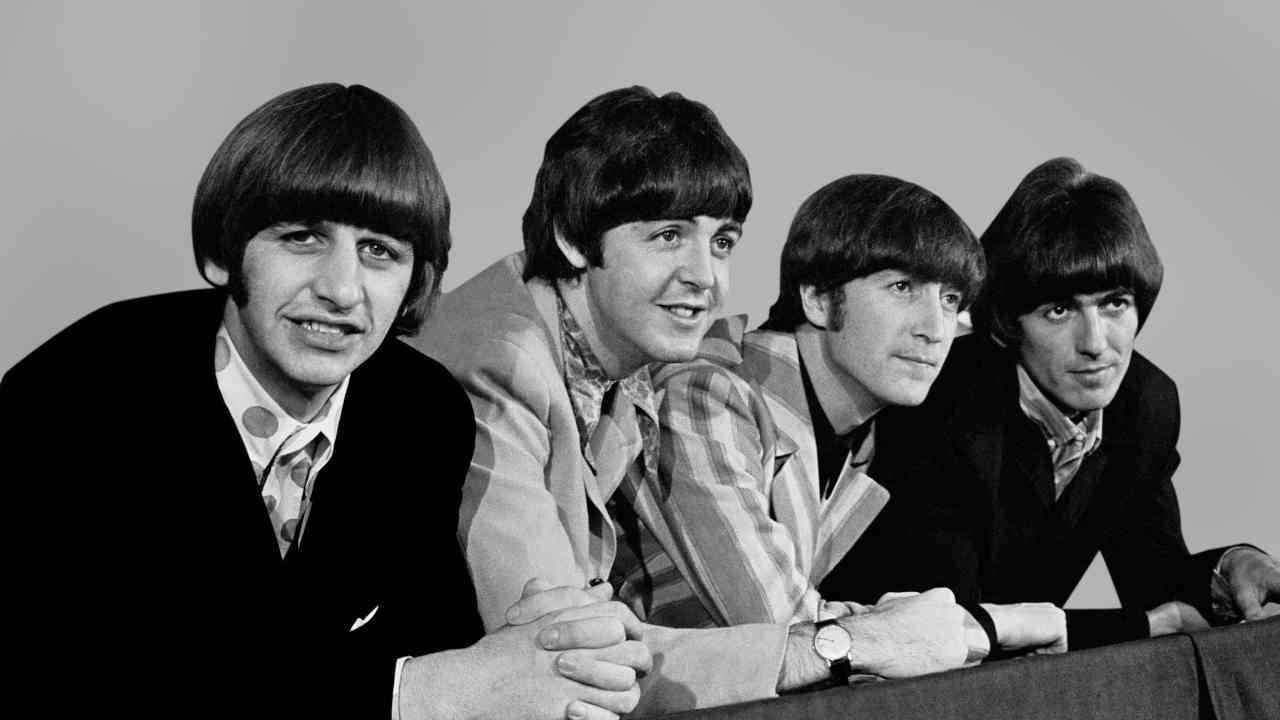 The Beatles posing for a photograph in 1966