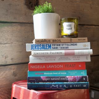 A red stool with a stack of cookbooks