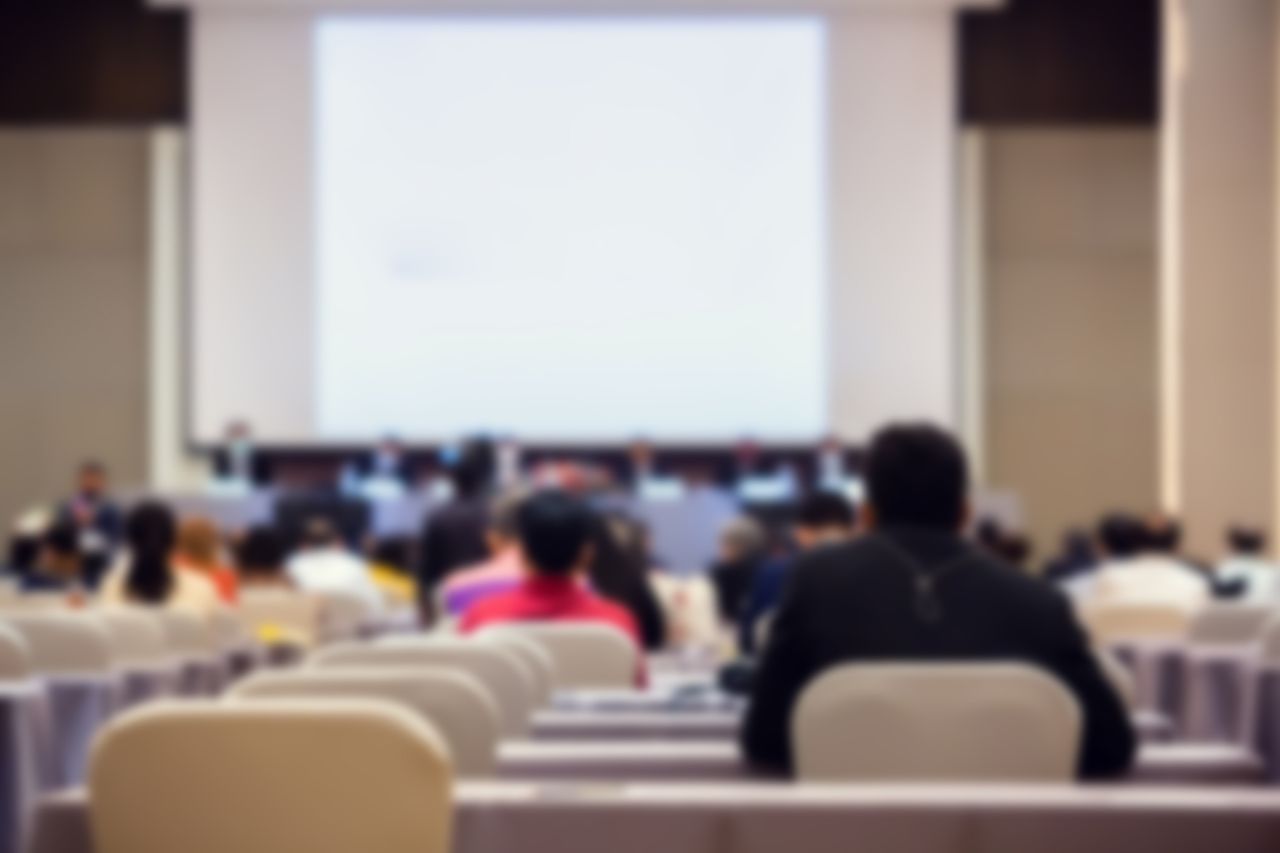 Blurry of auditorium for shareholders&#039; meeting or seminar event with projector.