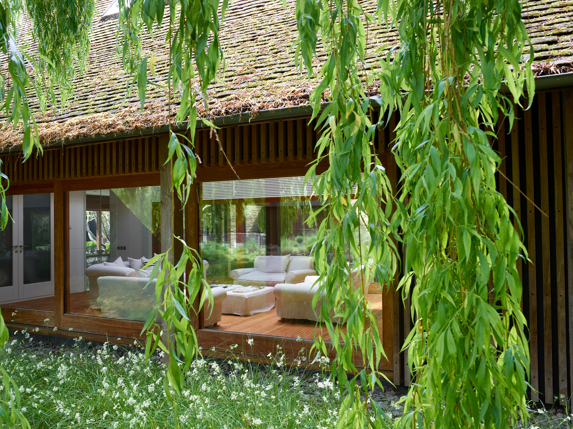 living room with white sofas viewed from the garden