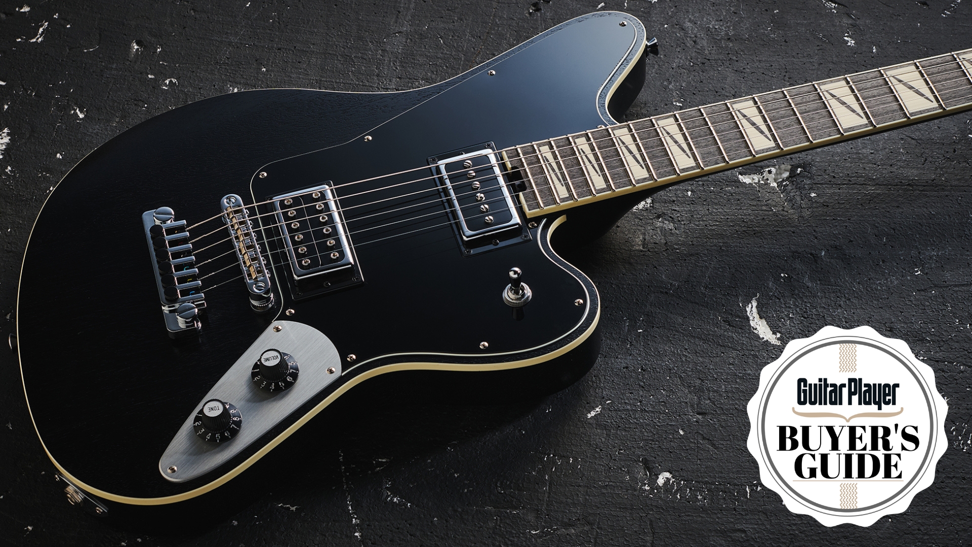 A Jackson Pro Series Lee Malia LM-87 electric guitar lying on a distressed, black floor