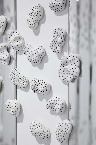 White ceramic wall fixtures with black spots