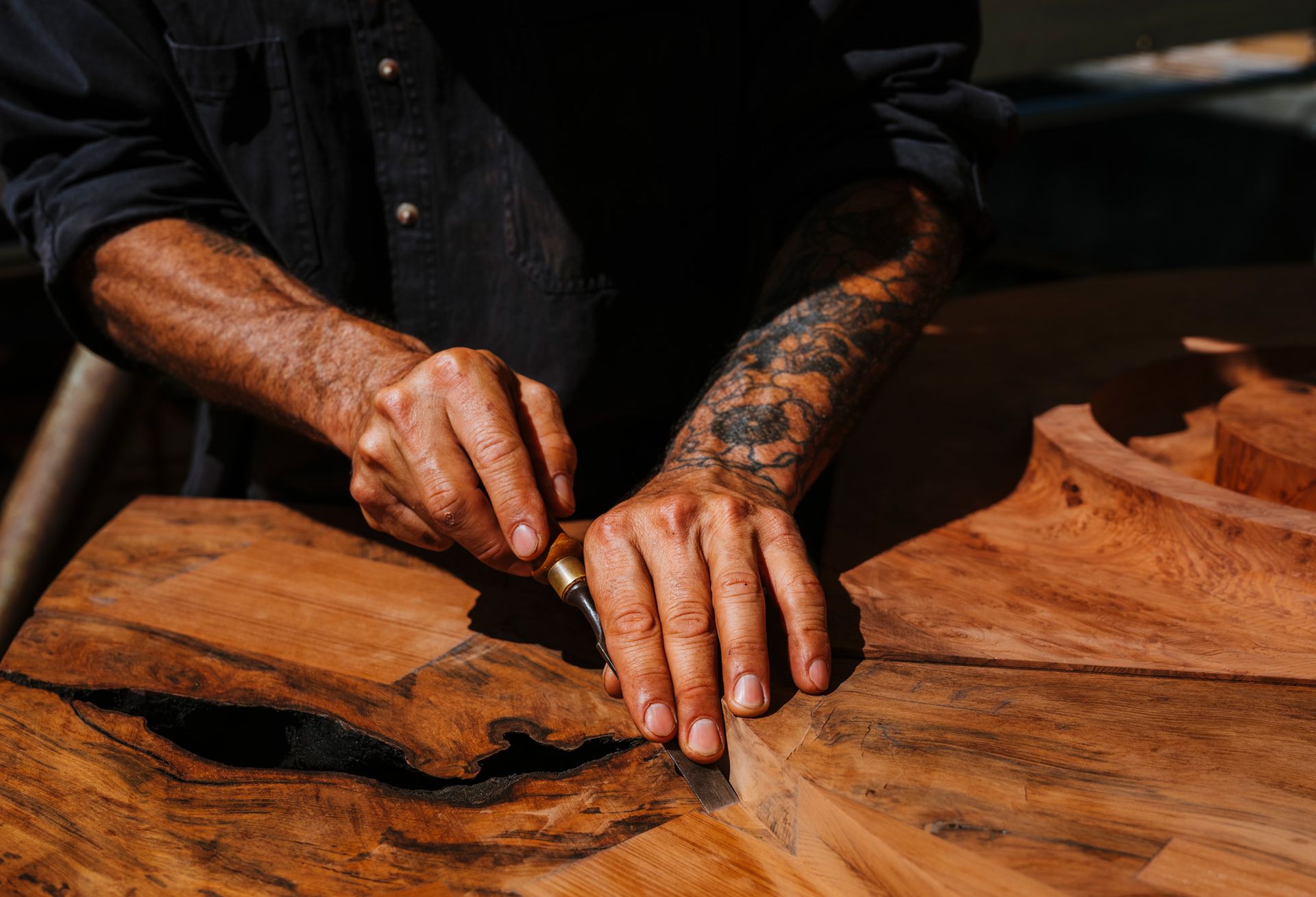 man's hands, carving wood