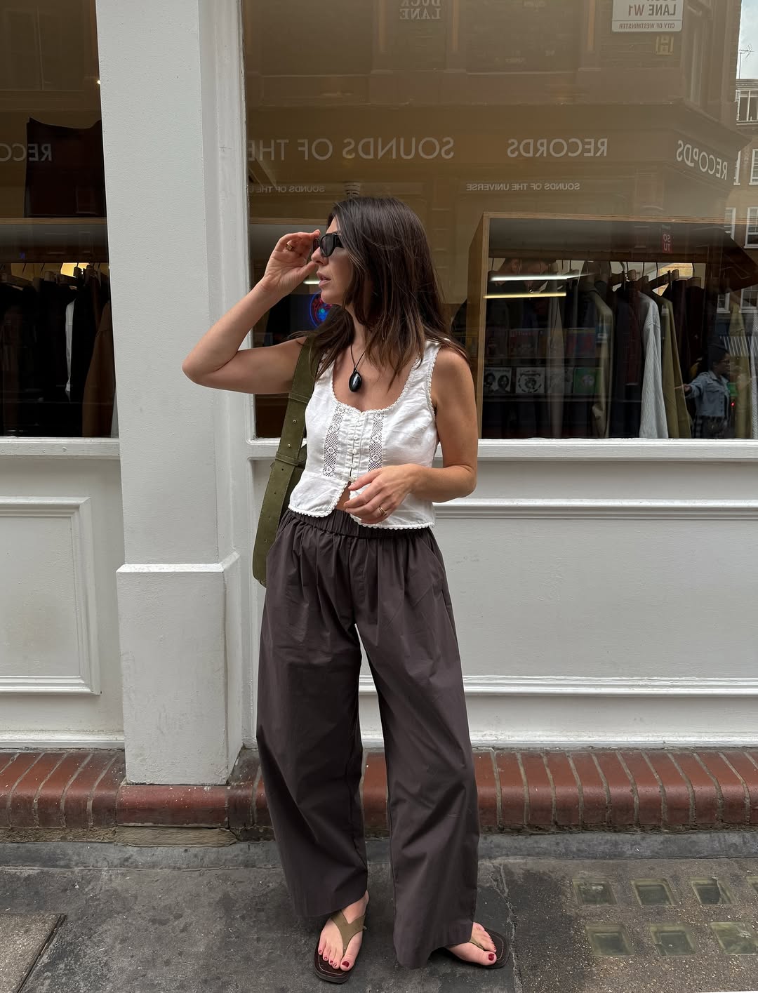 Francesca in suede sandals and brown trousers