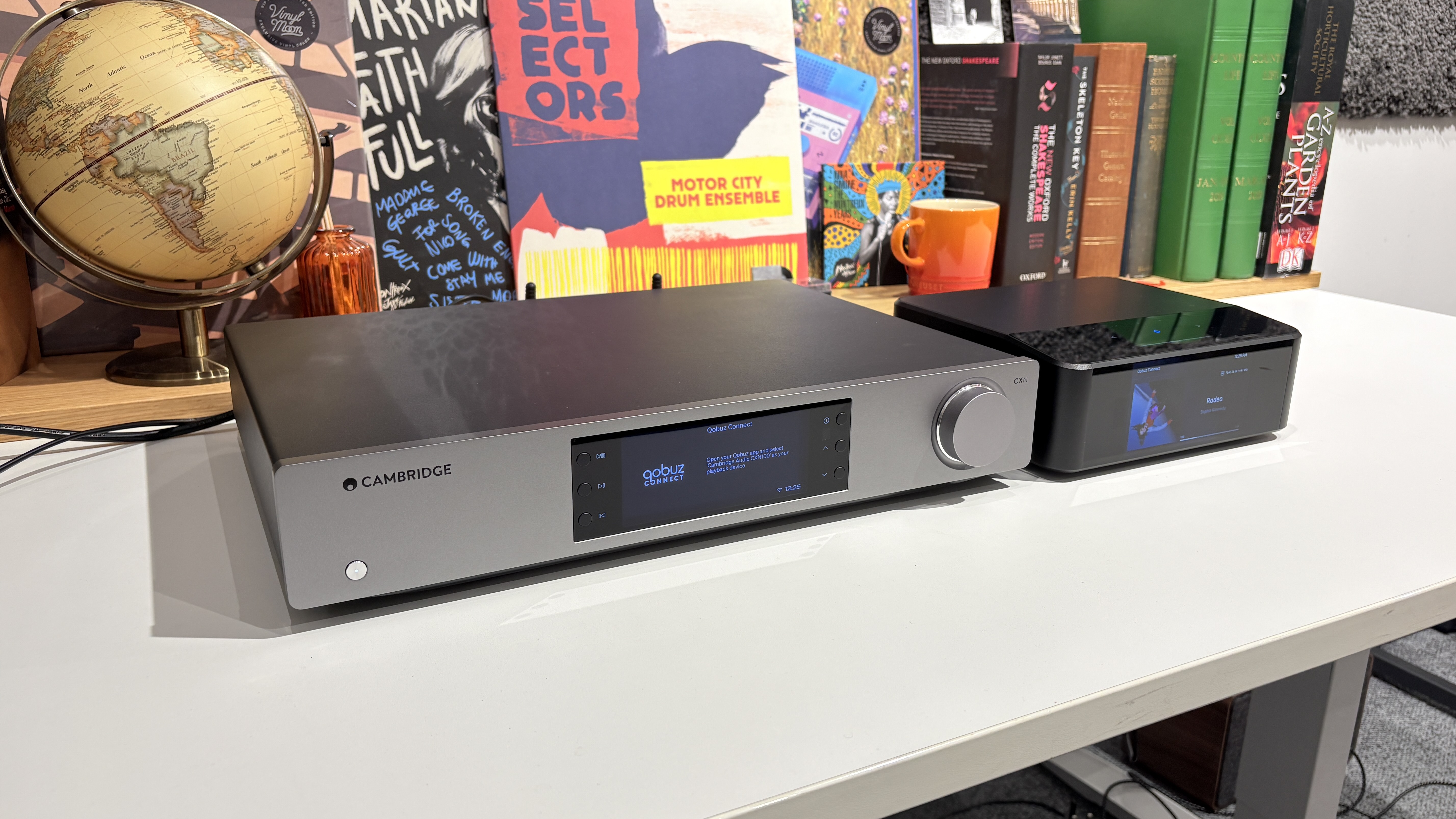 Bluesound Node Icon and Cambridge Audio CXN100 streamers placed next to each other on a white desk