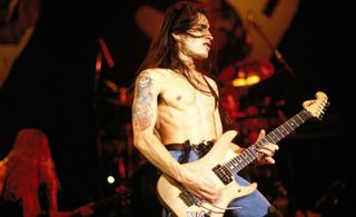 Nuno Bettencourt performs onstage with Extreme in 1990
