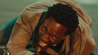 Tosin Cole screaming on the floor in Netflix's superhero series, Supacell