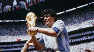 Diego Maradona of Argentina holds the World Cup trophy after Argentina beat West Germany in the final to win the 1986 FIFA World Cup in Mexico