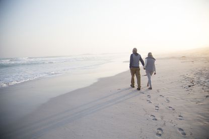 Senior couple walking on a beach together